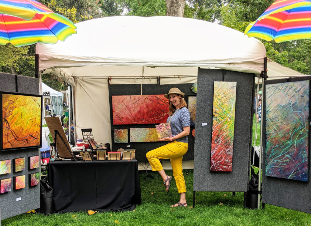 Lauren Kistner in front of her art fair booth